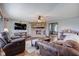 Spacious living room featuring brick fireplace, plush leather seating, and rustic wood accents at 4940 Sundance Trl, Indianapolis, IN 46239