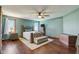 Spacious main bedroom featuring a ceiling fan, hardwood floors, and natural light at 4940 Sundance Trl, Indianapolis, IN 46239