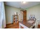 Well-lit home office with a desk, bookshelves, and hardwood floors at 4940 Sundance Trl, Indianapolis, IN 46239