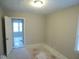 A cozy bedroom featuring neutral walls, a ceiling light, and a partially open door at 5080 Norwaldo Ave, Indianapolis, IN 46205
