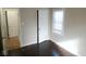 A bedroom featuring newly refinished hardwood floors, fresh paint, and a convenient closet at 5080 Norwaldo Ave, Indianapolis, IN 46205