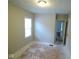A bright bedroom with a window, ceiling light, and exposed subfloor at 5080 Norwaldo Ave, Indianapolis, IN 46205