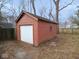 Exterior view of detached garage with overhead door and wood siding at 5080 Norwaldo Ave, Indianapolis, IN 46205