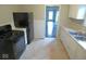 Efficient kitchen showcasing white cabinets and a sleek black refrigerator at 5080 Norwaldo Ave, Indianapolis, IN 46205