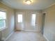 Bright room with light walls, tile floors and a door leading to the outside at 5080 Norwaldo Ave, Indianapolis, IN 46205