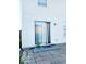 Sliding glass doors to backyard with brick patio and small blue cement landing at 5411 Cliff Ridge Dr, Indianapolis, IN 46217