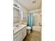 Traditional bathroom featuring a vanity, mirror, toilet, cabinet, and a bathtub with a blue floral shower curtain at 5411 Cliff Ridge Dr, Indianapolis, IN 46217