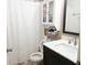 Bathroom featuring a dark vanity, a white toilet, white cabinets, and a shower with a white shower curtain at 5411 Cliff Ridge Dr, Indianapolis, IN 46217