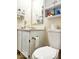 Bathroom with white cabinets, white toilet, and a wall mounted toothbrush holder at 5411 Cliff Ridge Dr, Indianapolis, IN 46217
