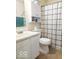 This bathroom features a toilet, white vanity, and a shower with a black and white checkered shower curtain at 5411 Cliff Ridge Dr, Indianapolis, IN 46217