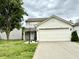 Charming two-story home featuring vinyl siding, a two-car garage, and a well-maintained front yard at 5411 Cliff Ridge Dr, Indianapolis, IN 46217