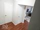 Hallway with wood laminate flooring leading to various rooms, facilitating easy movement throughout the house at 5411 Cliff Ridge Dr, Indianapolis, IN 46217