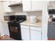 Efficient kitchen with white cabinets, and black appliances offering a practical and stylish space for cooking and meal preparation at 5411 Cliff Ridge Dr, Indianapolis, IN 46217