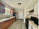 A functional kitchen with wood-toned cabinets, modern appliances, and plenty of countertop space for cooking at 5411 Cliff Ridge Dr, Indianapolis, IN 46217