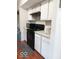 Well-organized kitchen with white cabinets, and black appliances offering a practical and stylish space for cooking and meal preparation at 5411 Cliff Ridge Dr, Indianapolis, IN 46217