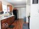 Traditional kitchen featuring wood cabinets, stainless steel sink, and black appliances, providing a functional cooking space at 5411 Cliff Ridge Dr, Indianapolis, IN 46217