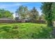 Grassy backyard with wood fence and a small fire pit at 5504 Indianola Ave, Indianapolis, IN 46220