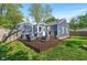 Home's backyard featuring a wood deck with outdoor seating, lawn, and a partial view of the house's exterior at 5504 Indianola Ave, Indianapolis, IN 46220