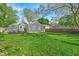 Spacious, grassy backyard with deck and partial view of the home's exterior at 5504 Indianola Ave, Indianapolis, IN 46220
