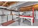 Basement with laundry area, workbench, and storage shelving on concrete flooring at 5504 Indianola Ave, Indianapolis, IN 46220