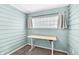 A home office with seafoam walls, carpet, and a white adjustable desk at 5504 Indianola Ave, Indianapolis, IN 46220