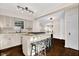 Bright kitchen featuring a granite island with seating, stainless steel appliances, and hardwood floors at 5504 Indianola Ave, Indianapolis, IN 46220
