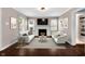Bright living room with a white fireplace, modern decor, and hardwood floors at 5504 Indianola Ave, Indianapolis, IN 46220