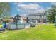 Backyard with an above ground pool, patio, and grassy yard at 562 Covered Bridge Rd, Greenwood, IN 46142