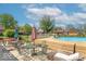 Backyard features an in-ground pool with a wooden deck, surrounded by comfortable seating for outdoor relaxation at 562 Covered Bridge Rd, Greenwood, IN 46142