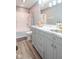 Bathroom with double sinks, grey cabinets, and white subway tile in the shower/tub at 562 Covered Bridge Rd, Greenwood, IN 46142