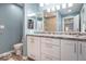Bathroom with white cabinets, dual sinks, grey marble countertop and a view into the shower and closet at 562 Covered Bridge Rd, Greenwood, IN 46142