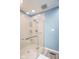 Modern bathroom with glass enclosed walk-in shower, light blue walls and light colored flooring at 562 Covered Bridge Rd, Greenwood, IN 46142
