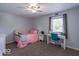 Bedroom featuring a ceiling fan, a window with blinds and curtains, and a desk in the corner at 562 Covered Bridge Rd, Greenwood, IN 46142