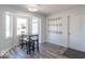 Bright breakfast nook with a bay window, modern light fixture, and coat hooks on the wall at 562 Covered Bridge Rd, Greenwood, IN 46142