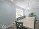 Dining room featuring a chandelier, and long dining table with room for ten next to bay window at 562 Covered Bridge Rd, Greenwood, IN 46142