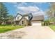 Charming two-story home with brick and siding, a well-maintained lawn, and a spacious driveway at 562 Covered Bridge Rd, Greenwood, IN 46142