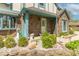 A quaint two-story house with brick facade and a garden, showcasing the inviting curb appeal at 562 Covered Bridge Rd, Greenwood, IN 46142