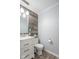 Stylish half bathroom featuring a wood accent wall, vanity with marble countertop, and modern fixtures at 562 Covered Bridge Rd, Greenwood, IN 46142