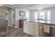 Bright open concept kitchen with white cabinets, stainless steel appliances, and light grey backsplash at 562 Covered Bridge Rd, Greenwood, IN 46142