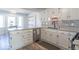 Bright kitchen with white cabinets, stainless steel appliances, and light grey backsplash at 562 Covered Bridge Rd, Greenwood, IN 46142
