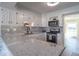 Kitchen featuring white cabinets, stainless steel appliances, light grey backsplash, and speckled countertop at 562 Covered Bridge Rd, Greenwood, IN 46142