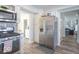 Kitchen with stainless steel fridge, white cabinets, stainless steel appliances, and view to other rooms at 562 Covered Bridge Rd, Greenwood, IN 46142