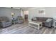 Open-concept living room with comfortable seating, wood-look floors, and soft color palette at 562 Covered Bridge Rd, Greenwood, IN 46142