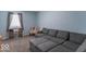A light blue living room features a grey sectional couch and ottoman with neutral carpet at 562 Covered Bridge Rd, Greenwood, IN 46142