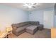A light blue living room features a grey sectional couch and ottoman with neutral carpet at 562 Covered Bridge Rd, Greenwood, IN 46142