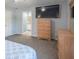 Serene main bedroom with a light blue wall, neutral carpet, and an ensuite bathroom at 562 Covered Bridge Rd, Greenwood, IN 46142