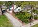 Aerial shot of the house featuring a brick chimney, mature trees, and a long driveway at 5938 Haverford Ave, Indianapolis, IN 46220