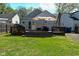 A spacious backyard featuring a wood deck with patio furniture and an umbrella at 5938 Haverford Ave, Indianapolis, IN 46220