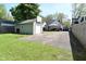 View of the home's backyard, including a garage, basketball hoop and concrete parking space at 5938 Haverford Ave, Indianapolis, IN 46220