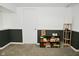 Finished basement area featuring neutral carpet, wainscoting, and a shelf full of games at 5938 Haverford Ave, Indianapolis, IN 46220